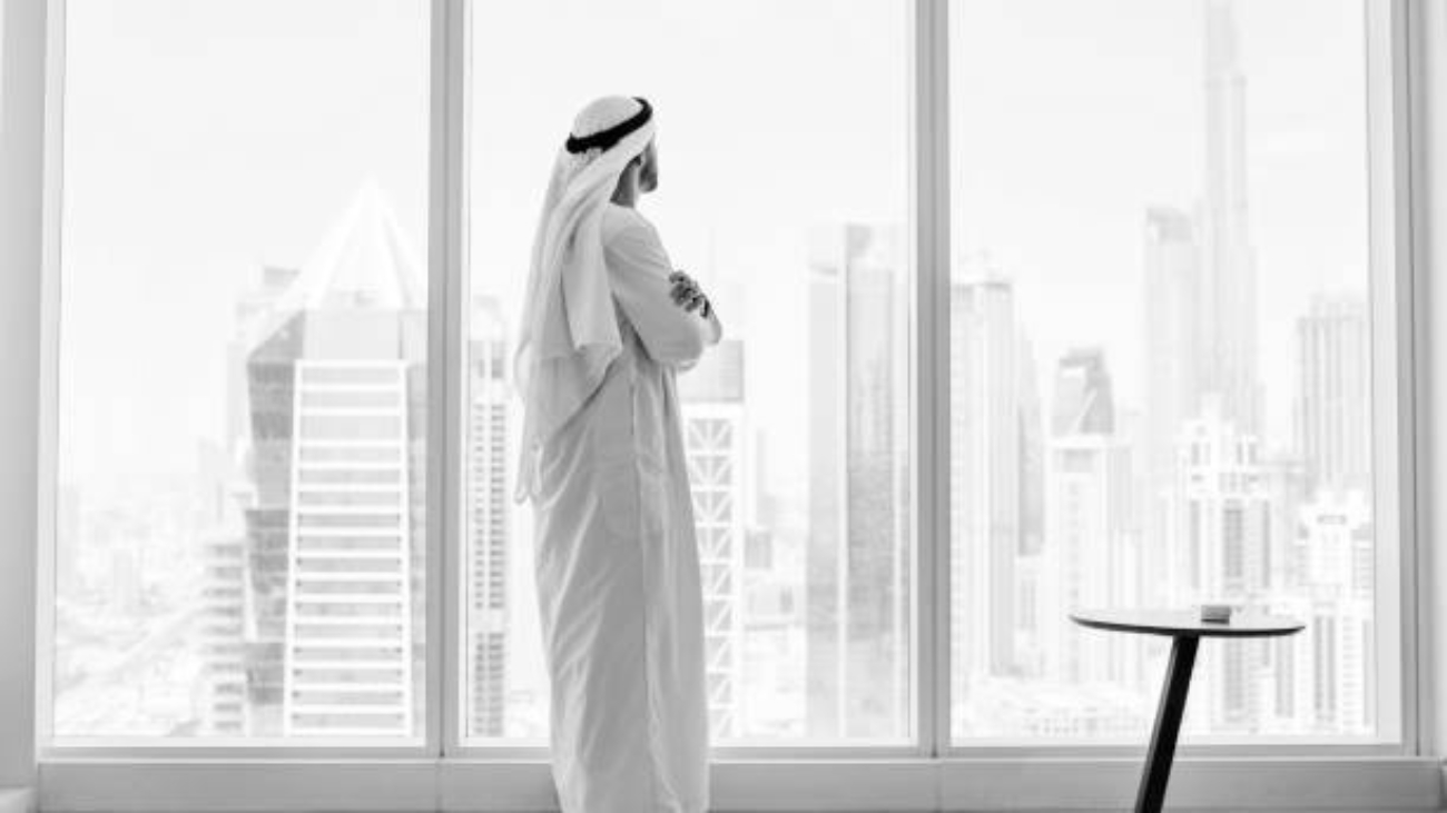 side-view-of-arab-businessman-looking-through-window-in-modern-office__1__jpeg_copy_jpeg